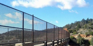 One inch 'non-climb' fabric prevents people from scaling the fence without the need for a curved top. American Fence installed this project ahead of schedule and on-budget.