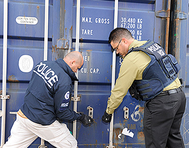 HSI Agents accessing a cargo box