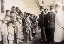 Japanese immigrants being examined by U.S. immigration officials aboard a ship docked at Angel Island (Image courtesy of the National Archives, Washington, D.C.)