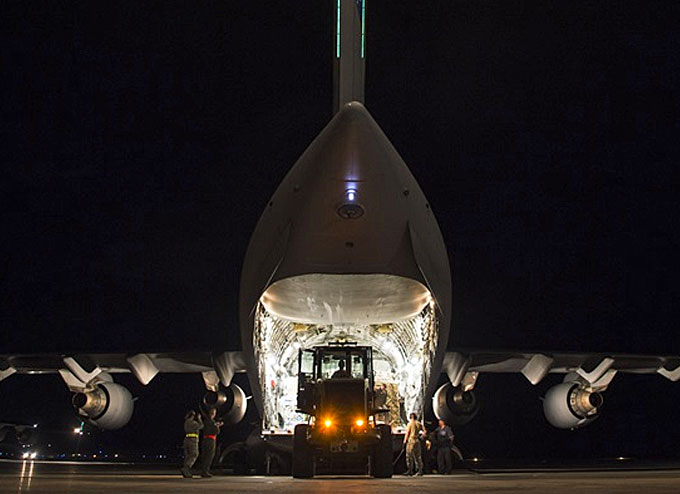 A C-17 Globemaster III sits on the flightline with over 130,000 pounds of meals ready to eat and water were transported to St. Croix and distributed to provide relief efforts to those affected by Hurricanes Irma and Maria. (Image courtesy of U.S. Air Force by Senior Airman Clayton Cupit)