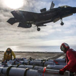 Sailors assigned to amphibious assault ship USS America (LHA 6) and F-35B Lightning II Marine Corps personnel prepared to equip the aircraft with 500-pound GBU-12 Paveway™ II Plus Laser Guided Bombs during F-35B flight test operations in the Pacific Ocean. (Image courtesy of the U.S. Navy)