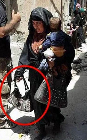 A female suicide bomber was seen carrying a baby shortly before she died in July of 2017 (Image courtesy of Al-Mawsleya TV)