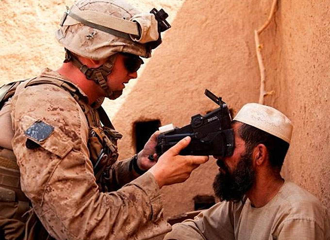 U.S. Marine from Fox Company, 2nd Battalion, 2nd Marine Regiment (2/2) scans an Afghan man's retinas using a Biometric Enrollment and Screening Device (BESD) while conducting counter-insurgency operations in Helmand province, Afghanistan. (Image courtesy of U.S. Marine Corps)