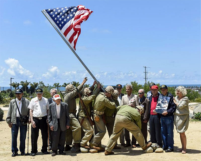 Iwo Jima veterans gathered about 100 yards east of the future monument and memorial site. Pictured from left to right (not including re-enactors): Damasio Sutis; John Farritor; Col. Michael Naylor; Chuck Amador; Jim Scotella, Chuck Bahde (Army Air), Robert Bergen (Navy); Edward McHenry "Iron Mike" Mervosh, honorary national chairman of Iwo Jima Monument West; and Laura Dietz, founder. (Image courtesy of Iwo Jima West Monument/Operation Home of the Brave)