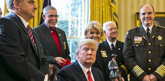 President Donald Trump, who made “law and order” a central issue of his campaign and enjoyed wide support among members of the law enforcement community, shown here meeting with a group from the National Sheriffs’ Association at the White House, delivering a letter of thanks for his recent executive actions to clamp down on illegal immigration.