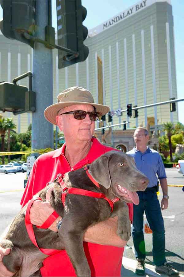 FBI Las Vegas Chaplain Gary Morefield holds Wrangler the dog while providing spiritual support and general comfort to those at the scene after the October 1, 2017 mass shooting in Las Vegas. (Image courtesy of the FBI)