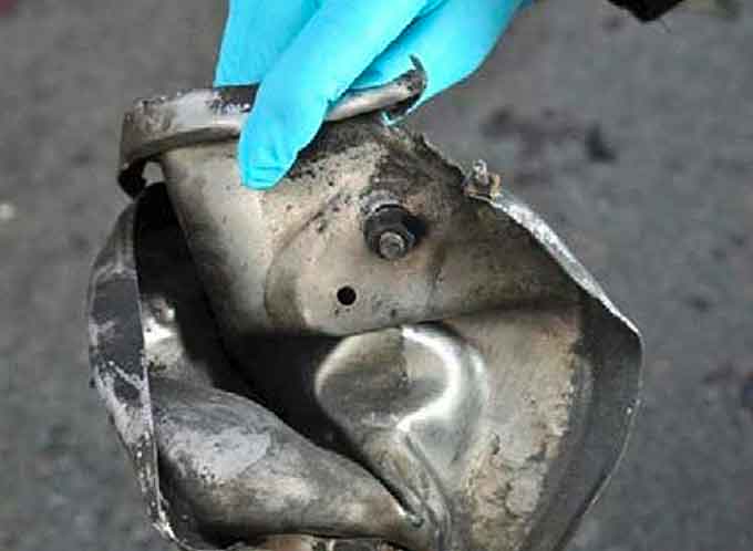 A pressure cooker bomb, like the ones used in the 2013 Boston Marathon bombing, is an IED created by inserting explosive material into a pressure cooker and attaching a blasting cap. Pictured here, a piece of one of the Boston Marathon 2013 bombs, believed to be a pressure cooker, which was discovered the day after the April 15, 2013 explosion. (Image courtesy of the FBI)