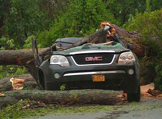 A powerful storm battered the Northeast Tuesday, with drenching rain, golf-ball-sized hail and deadly winds, which killed at least two, including an SUV that was flattened by a falling tree, killing an 11year old girl who had been sitting in her mother's car as she unloaded groceries, and knocking out power to hundreds of thousands of homes and businesses. (Image courtesy of YouTube)