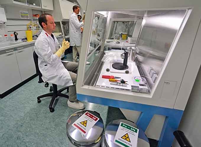 Experts in the Nuclear Material Laboratory use specialized tools to carefully analyse samples of nuclear material as part of the safeguards verification process. (Courtesy of D. Calma, IAEA)