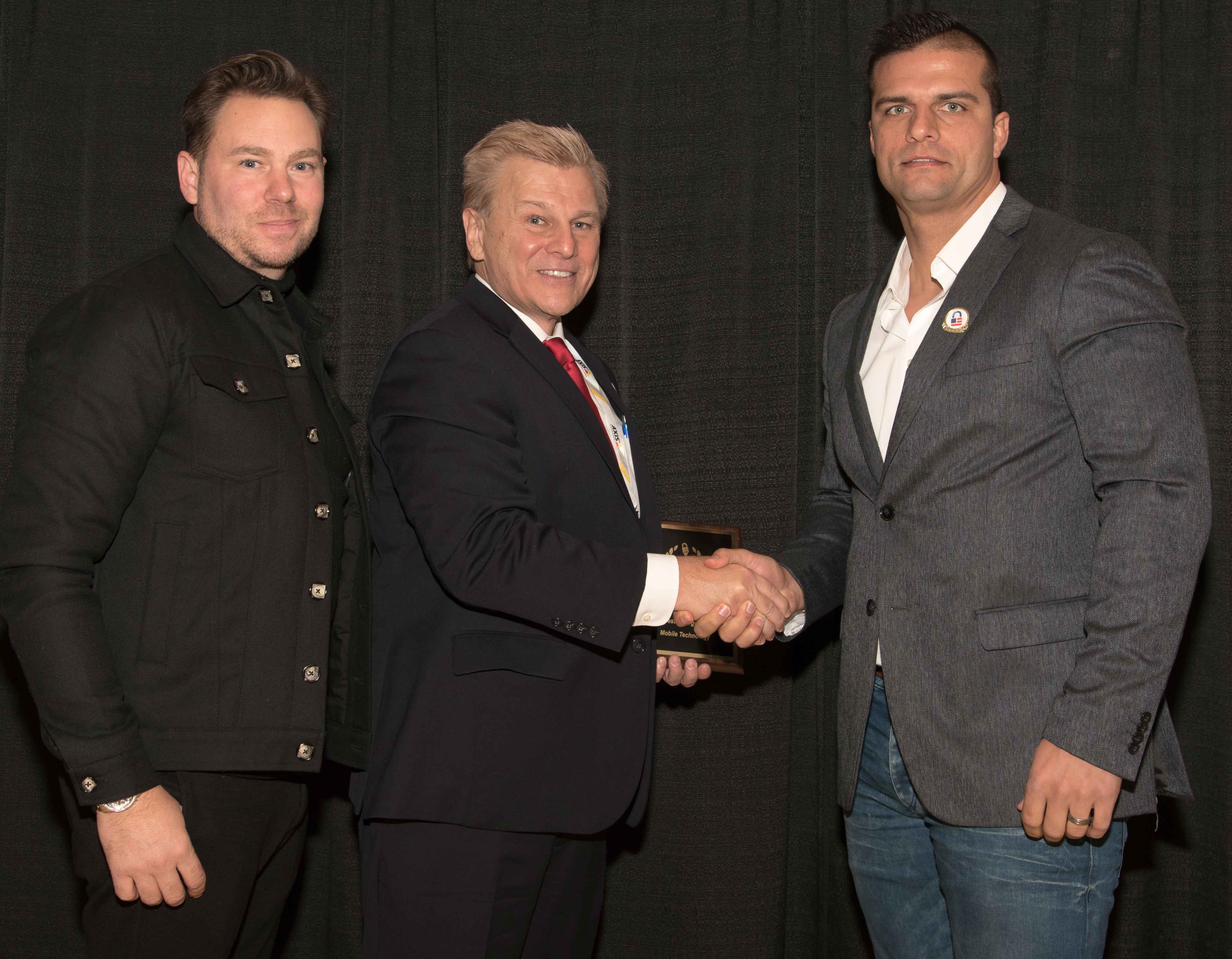 Jaromy Jannard-Pittario, COO (at left), and Barry Oberholzer, CEO (at right), Co-Founders of Royal Holdings, being presented a 2017 ‘ASTORS’ Homeland Security Award at ISC East.