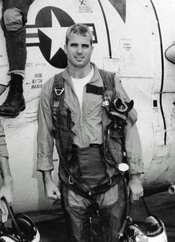 McCain shown here with his squadron and a T-2 Buckeye trainer in 1965, taken two years before he was captured and was forced to spend five and a half years in captivity as a POW in North Vietnam. 