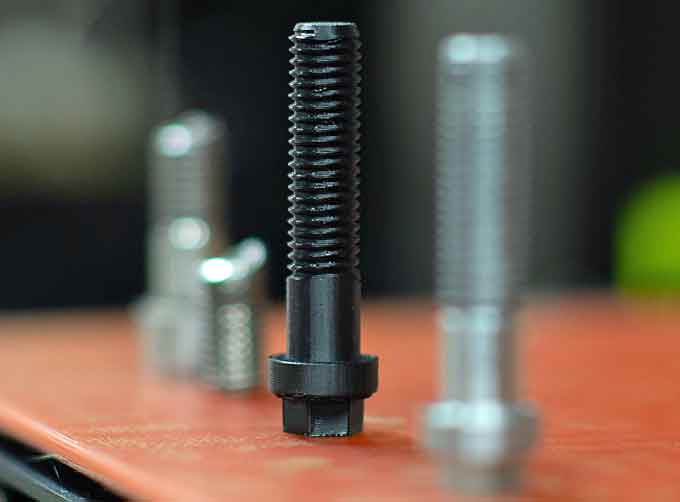 A 3D printed bolt, a broken bolt, and the final manufactured bolt for a hangar bay door assembly sit from left to right on a 3D printer aboard the Nimitz-class aircraft carrier USS John C. Stennis (CVN 74). (Courtesy of the U.S. Navy photo and Mass Communication Specialist 3rd Class Grant G. Grady)