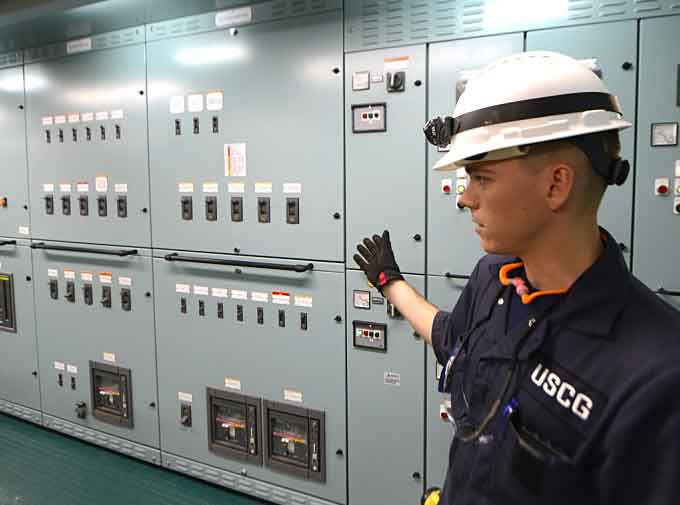Lt. j.g. Ryan Thomas, a marine Inspector at Coast Guard Sector Delaware Bay, discusses the Coast Guard’s role and procedures during electrical testing aboard the Daniel K. Inouye. (Courtesy of USCG by Petty Officer 1st Class Seth Johnson)
