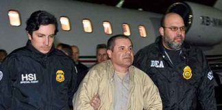 In this photo provided U.S. law enforcement, authorities escort Joaquin “El Chapo” Guzman, center, from a plane to a waiting caravan of SUVs at Long Island MacArthur Airport on Thursday, Jan. 19, 2017, in Ronkonkoma, N.Y. The infamous drug kingpin who twice escaped from maximum-security prisons in Mexico was extradited at the request of the U.S. to face drug trafficking and other charges, and landed in New York late Thursday, a federal law enforcement official said. (Courtesy of ICE)