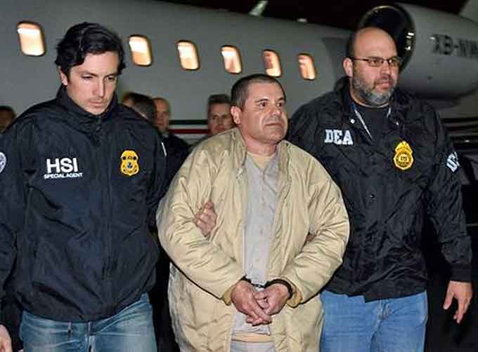 In this photo provided U.S. law enforcement, authorities escort Joaquin “El Chapo” Guzman, center, from a plane to a waiting caravan of SUVs at Long Island MacArthur Airport on Thursday, Jan. 19, 2017, in Ronkonkoma, N.Y. The infamous drug kingpin who twice escaped from maximum-security prisons in Mexico was extradited at the request of the U.S. to face drug trafficking and other charges, and landed in New York late Thursday, a federal law enforcement official said. (Courtesy of ICE)