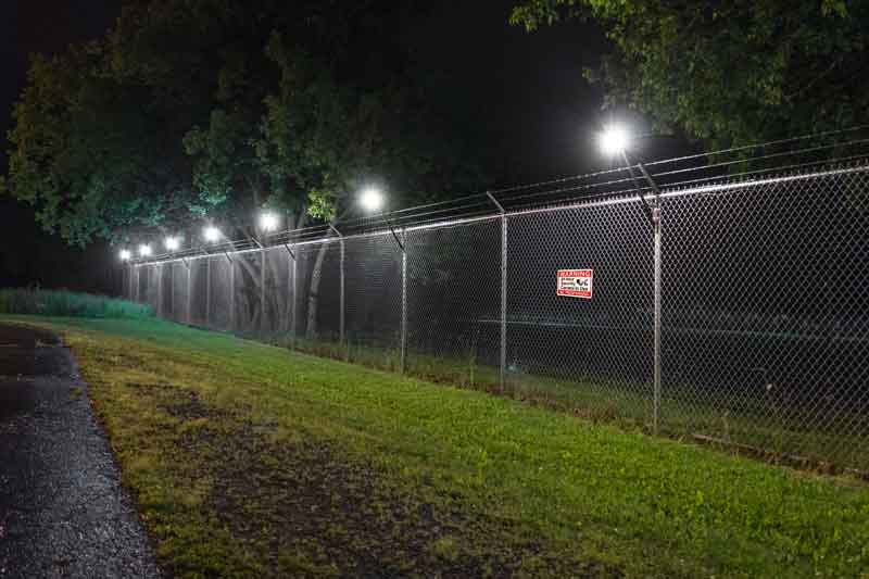 The Senstar LM100 Perimeter Intrusion Detection and Intelligent Lighting System uses an encrypted self-healing wireless mesh network for communication between luminaires. This eliminates the need to run communications wiring along the fence. The mesh network also maintains communications if several of the fixtures are physically damaged or have their power supply cut off.
