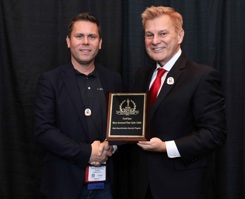 Christian Peterson, III, President of TiniFiber accepting a 2018 ‘ASTORS’ Award at ISC East.
