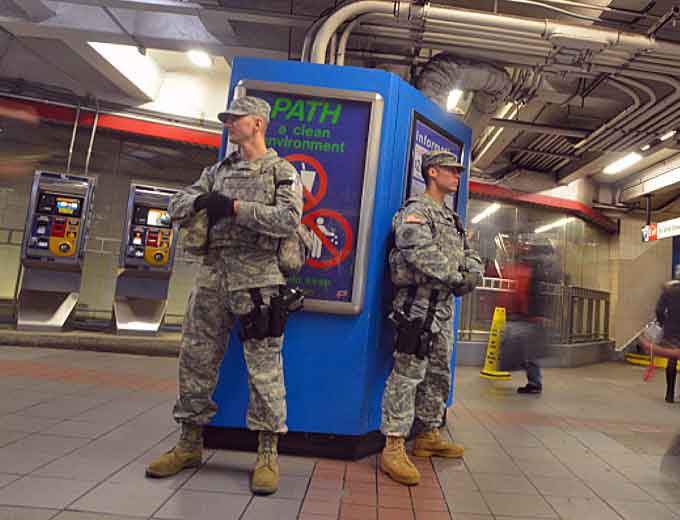 A New York National Guard Soldier and Airman assigned to Joint Task Force Empire Shield keep an eye on the crowd coming and going in New York City's Pennsylvania Station Amtrak terminal on Tuesday, Dec. 23, 2014. The two are part of the New York National Guard's 500-member State Active Duty force that assists the Metropolitan Transit Authority Police Department, the Bridge and Port Authority Police Department and the Amtrak Police at New York City's airports and key transit terminals. The uniformed National Guard members do not have arrest authority but provide additional eyes and assist police when requested. (Courtesy of National Guard by Staff Sgt. Christopher S. Muncy)
