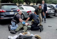 The gunman, identified as Brian Isaack Clyde, was seen on video near the doors to the Earle Cabell Federal Building at about 8:50 a.m. before running across the street and into a parking lot, where he falls down. (Courtesy of The Dallas Morning News, Tom Fox, and YouTube)