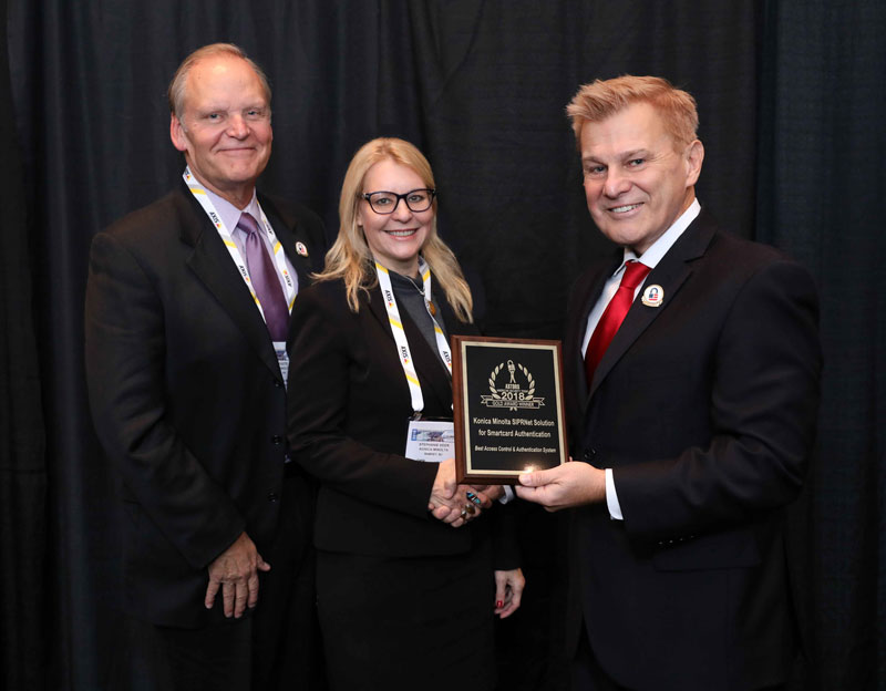 Todd Foote, Konica Minolta VP, Government Sales and Marketing , and Stephanie Keer, PhD, Director of National Practice and Gov’t, accepting a 2018 ‘ASTORS’ Award at ISC East.