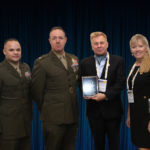 Colonel Seth Milstein and Master Gunnery Sergeant Carlos Torres accepting the 1700 Cyberspace OccFld Platinum 'ASTORS' Award at the 2019 'ASTORS' Awards Luncheon at ISC East.