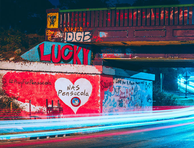 The Graffiti Bridge over 17th Avenue just before midnight on December 6, 2019 following the events at NAS Pensacola. Painted by a local resident. (Courtesy of Wikipedia.)
