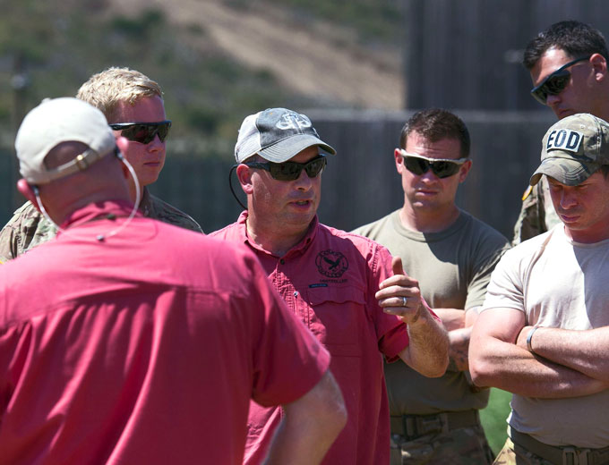 FBI bomb technician Ian Bruce Vabnick, center, who has a doctoral degree in physics, gives a field lecture to explosive ordnance disposal units from the Air Force, Army, and Marine Corps during the Raven’s Challenge exercise at Camp Pendleton, Calif., Aug. 3, 2017. The exercise is funded by the Army and led by the Bureau of Alcohol, Tobacco, Firearms, and Explosives with participants from federal, state and local law enforcement agencies. Courtesy of the DoD by EJ Hersom)