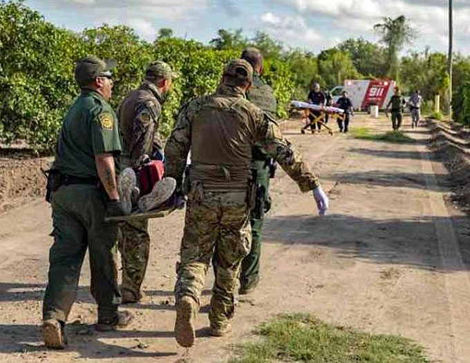 The U.S. Border Patrol, which was was honored in the 2019 ‘ASTORS’ Awards Program for ‘Excellence in Homeland Security’, renders medical aid to a migrant suffering from a heat-related illness found in an orange grove. (Courtesy of CBP by Mani Albrecht)