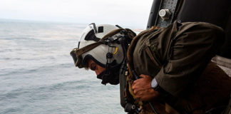 Naval Air Crewman 2nd Class Joseph Rivera, a search and rescue swimmer looking out of a US Navy MH-60 Seahawk, helped conduct the search and rescue relief operations. (Courtesy of 15th MEU by Lance Cpl. Mackenzie Binion and Twitter)