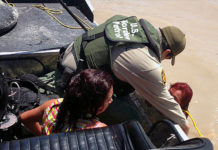 Border Patrol agents from Eagle Pass, Texas, rescue two a woman and her daughter from the Rio Grande River. The journey that illegal border crossers take from their home countries is extremely dangerous, and the danger is more severe during the COVID-19 pandemic. Border Patrol agents from Eagle Pass, Texas, rescue two young women from the Rio Grande River. (Courtesy of CBP by Agent Carl Nagy.)