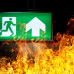 Green,Fire,Escape,Sign,Hang,On,The,Ceiling,In,The