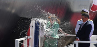 Sarah Greenert McNichol, Matron of Honor for the pre-commissioning unit (PCU) Hyman G. Rickover (SSN 795), christens the ship during a ceremony at General Dynamics Electric Boat shipyard facility in Groton, Conn., July 31, 2021. (Courtesy of the U.S. Navy by Chief Petty Officer Joshua Karsten.)