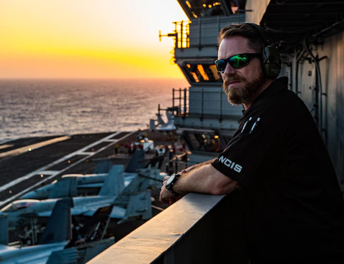 Special Agent Afloat Nate O’Connor on board the aircraft carrier USS George H. W. Bush (CVN-77), deployed in the Mediterranean Sea. (Courtesy of the U.S. Navy by Jared Harral)