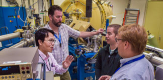 Sandia National Laboratories researchers, from left, Yuan-Yu Jau, George Burns, Justin Christensen and Ed Bielejec plan to test a future neutron generator for an electric-field imaging system at Sandia’s Ion Beam Laboratory, pictured here. (Courtesy of Sandia Labs by Randy Montoya)