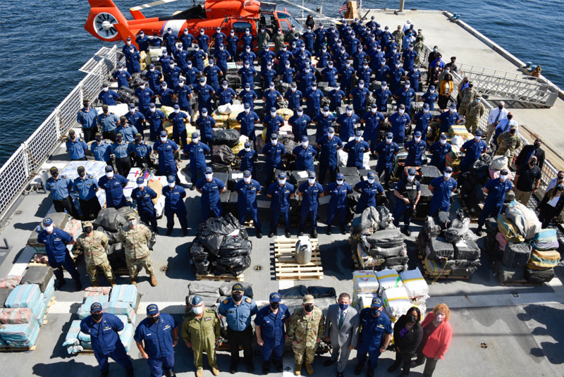 The Coast Guard Cutter James and Canadian Royal Navy Shawinigan crews pose with approximately 59,700 pounds of cocaine and 1,430 pounds at Port Everglades, Florida, Aug. 5, 2021. The James is homeported in Charleston, South Carolina. (Courtesy of the U.S. Coast Guard by Petty Officer 3rd Class Ryan Estrada)