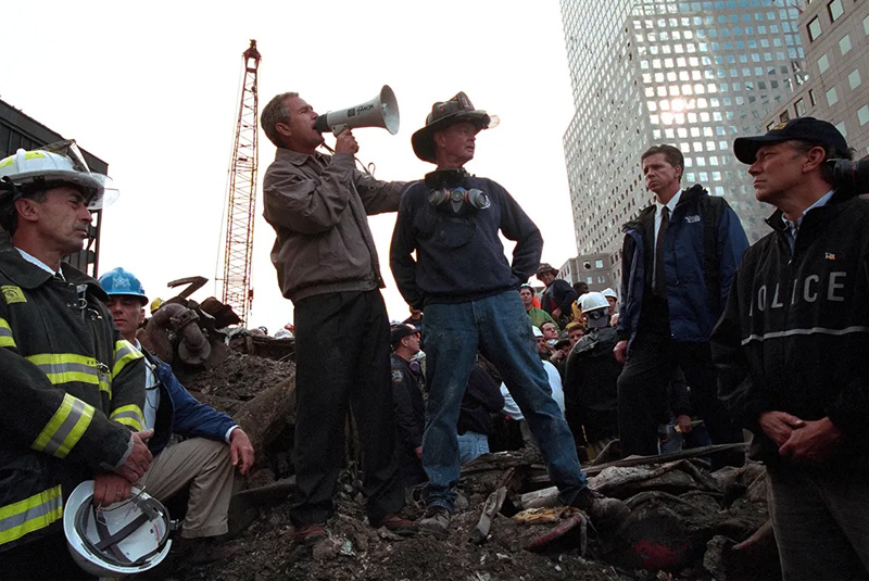 U.S. President George W. Bush visited Ground Zero, standing with rescue workers, firefighters and police officers atop smoldering rubble of the fallen Twin Towers, giving a speech that still echoes 20 years later. (Courtesy of YouTube)