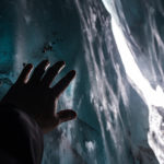 Hand,Reaching,The,Ice,Inside,A,Cave,In,Matanuska,Glacier,