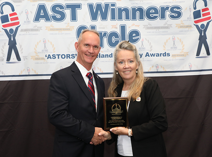 Malcolm Parrish, Training Specialist with the DHS/CISA Interagency Security Committee, accepts a 2022 'ASTORS' Award for its Risk Mgmt Process and Facility Security Committee Training Course.