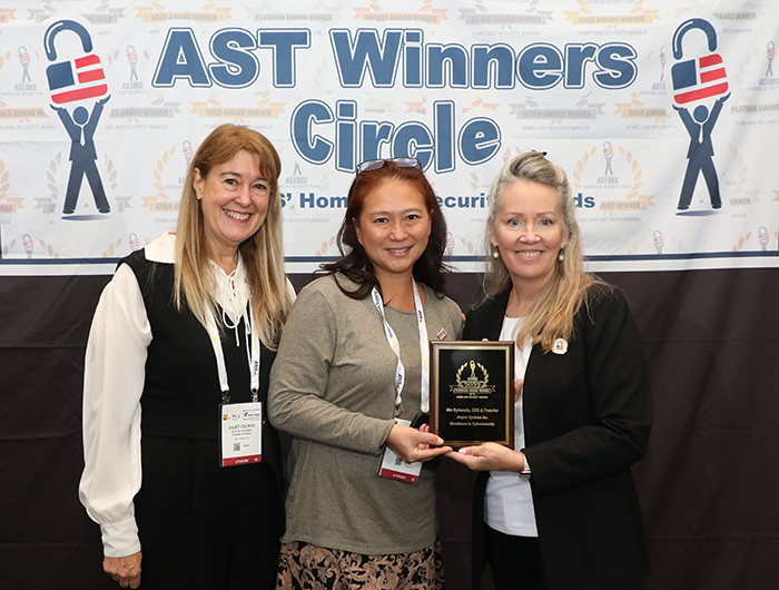Min Kyriannis, CEO & Founder of Amyna Systems Inc. (center); together with Juliet Colman, Founder of SecurityWomen, accepts a 2022 Excellence in Cybersecurity Award in the 2022 ‘ASTORS’ Homeland Security Awards Ceremony in New York City. 