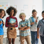 Portrait,Of,Cheerful,Smiling,Diverse,Schoolchildren,Standing,Posing,In,Classroom